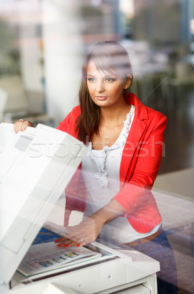 Pretty young female college student/secretary using a copy machine Stock photo © lightpoet