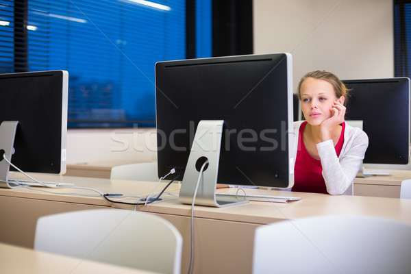 Pretty, young female college student using a desktop computer Stock photo © lightpoet