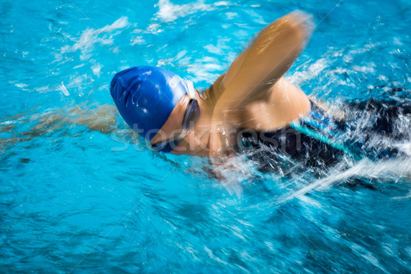 Female swimmer in an indoor swimming pool - doing crawl Stock photo © lightpoet