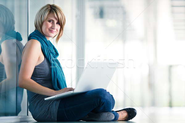 Pretty female student with a laptop computer on university campus Stock photo © lightpoet