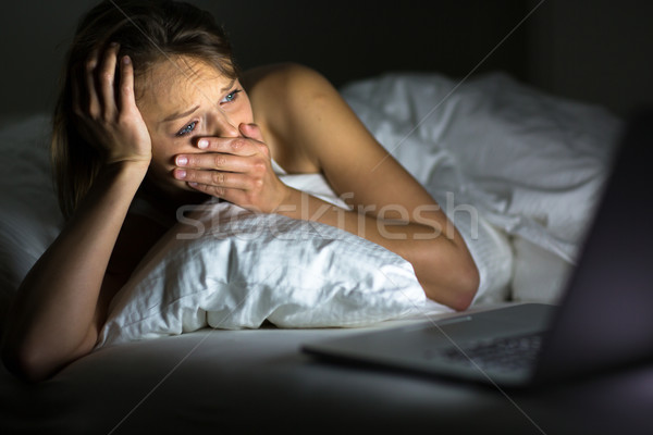Pretty young woman watching something awful/sad on her laptop in Stock photo © lightpoet