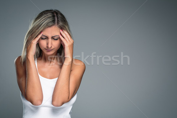 Stock photo: Gorgeous young woman with severe headache/migraine/depression