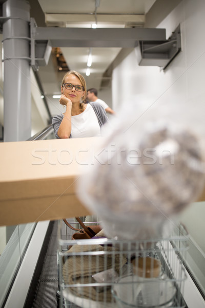 Pretty, young woman choosing the right furniture Stock photo © lightpoet