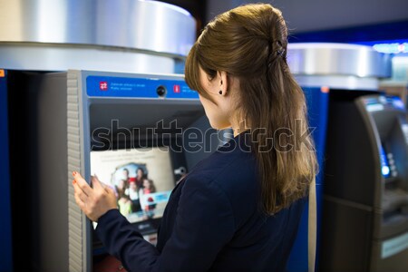Pretty, young woman withdrawing money from her credit card Stock photo © lightpoet