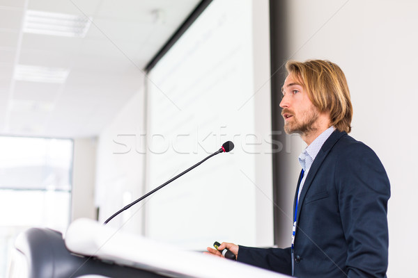 Handsome young man giving a speech at a conference Stock photo © lightpoet