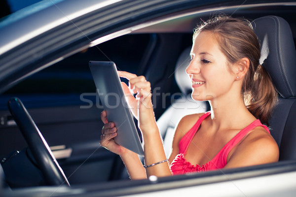 Pretty, female driver using her tablet computer Stock photo © lightpoet