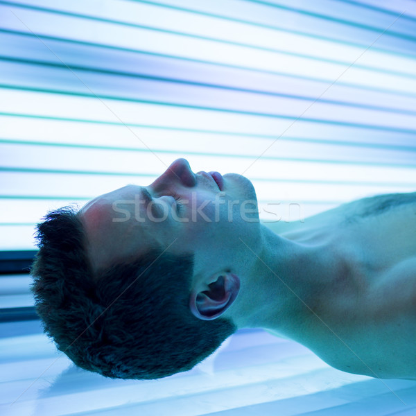 Jóképű fiatalember megnyugtató napozás modern szolárium Stock fotó © lightpoet
