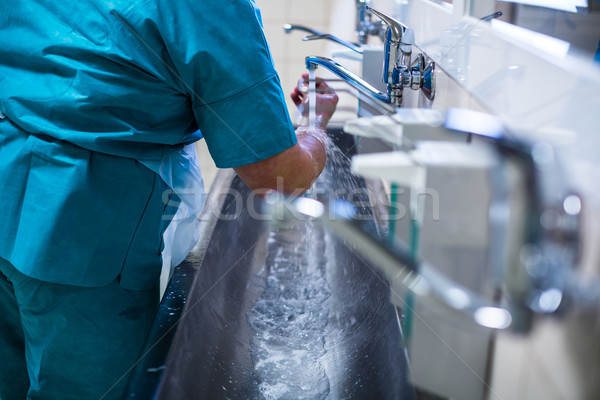 Surgeon in hospital washing thorouughly his hands Stock photo © lightpoet