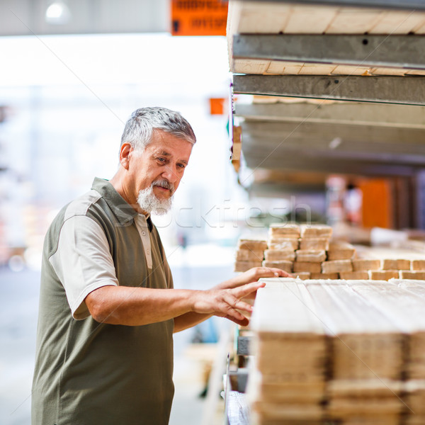 Stock photo: Man choosing and buying construction wood in a  DIY store