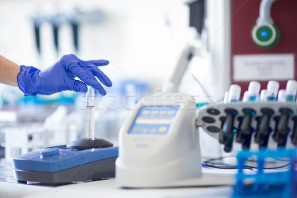 Stock photo: Hands of a female researcher doing research in a lab