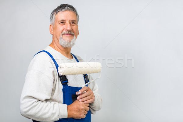 Senior man posing with a paint roller  Stock photo © lightpoet