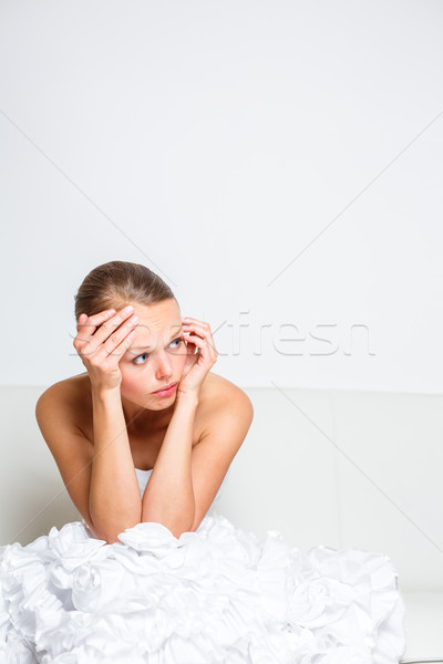 Sad bride crying sitting on a sofa, smitten, pondering Stock photo © lightpoet