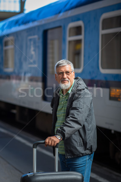 Handsome senior man taking a train, waiting for his family Stock photo © lightpoet