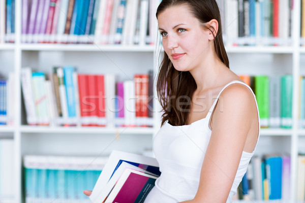 pretty female college student studying in the university library Stock photo © lightpoet