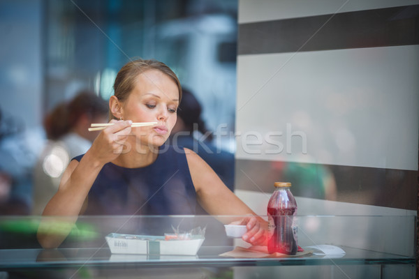 Pretty, young woman eating sushi in a restaurant Stock photo © lightpoet