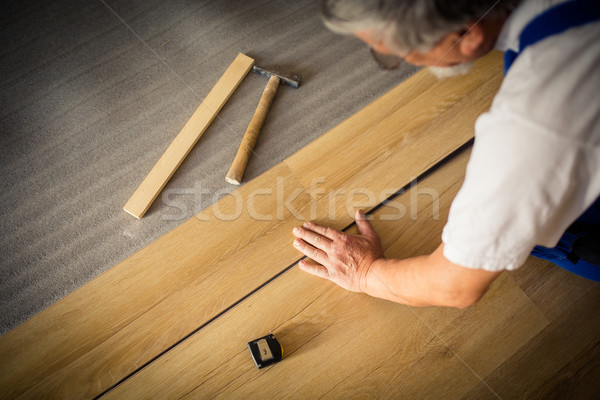 Close up of male hands lying parquet floor board/laminate flooring  Stock photo © lightpoet