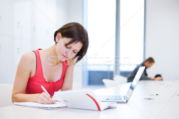 Pretty young college student studying in the library/a study roo Stock photo © lightpoet