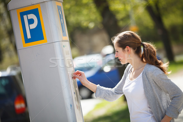 Stock photo: Young woman paying for parking 