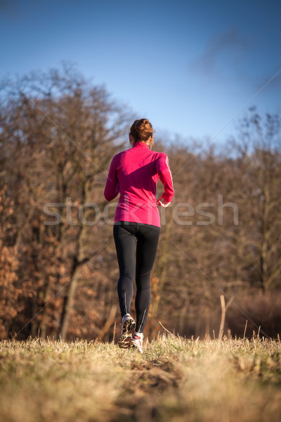 Young woman running outdoors on a lovely sunny winter/fall day  Stock photo © lightpoet