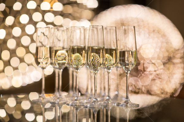 Champagne flutes on shiny, glassy background  Stock photo © lightpoet