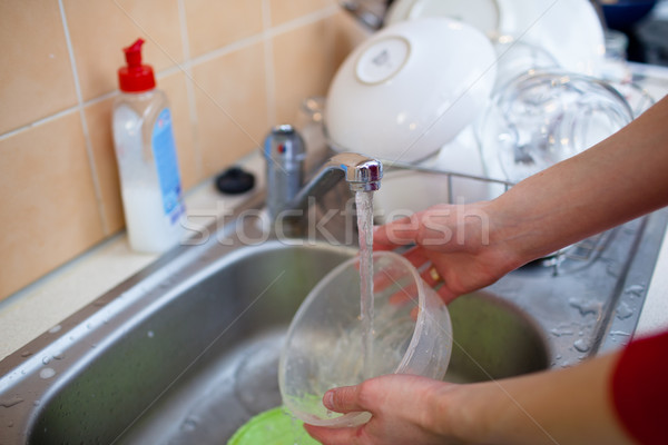  woman hands rinsing dishes under running water in the sink Stock photo © lightpoet