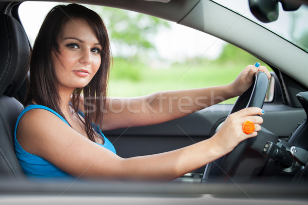 Pretty young woman driving her new car  Stock photo © lightpoet