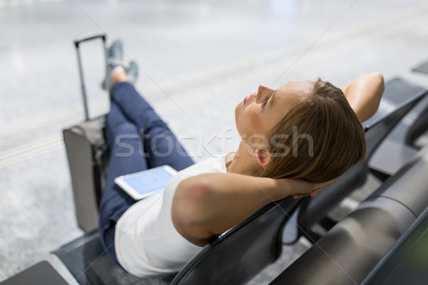 Young female passenger at the airport, using her tablet computer Stock photo © lightpoet