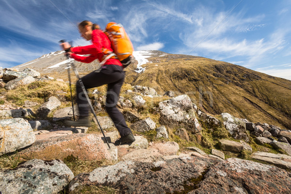 Stock photo: Pretty, young female hiker going uphill