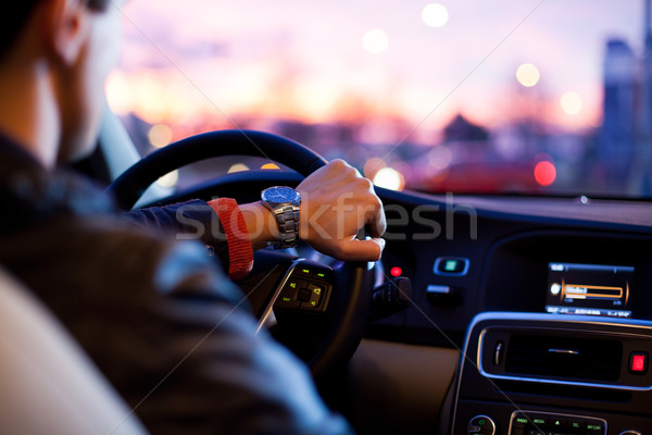 Hombre conducción moderna coche noche ciudad Foto stock © lightpoet