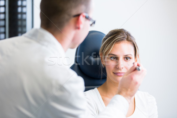 optometry concept - pretty young woman having her eyes examined  Stock photo © lightpoet