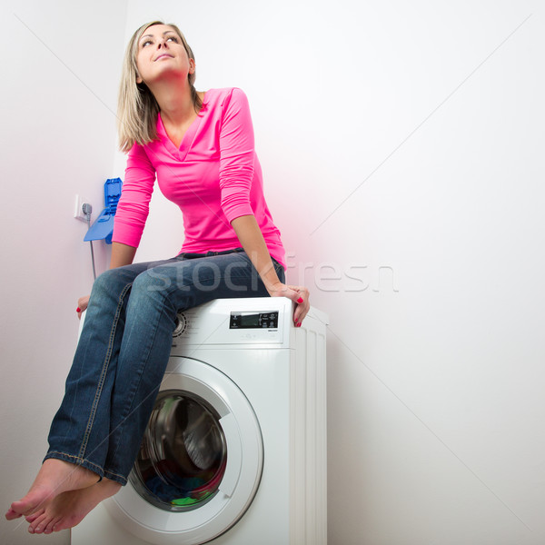 Stock photo: Housework: young woman doing laundry