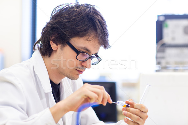 Stock photo: Male researcher carrying out scientific research in a lab (shall