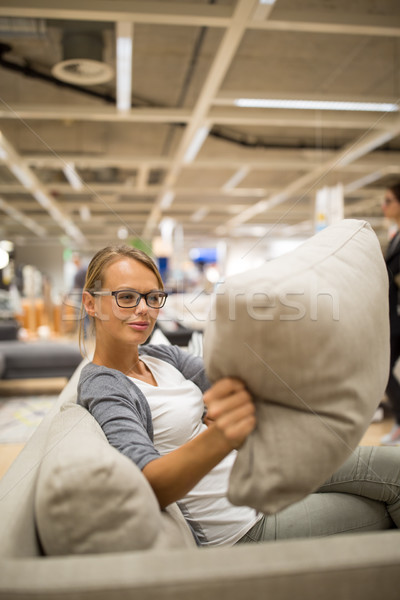 Pretty, young woman choosing the right furniture for her apartment Stock photo © lightpoet
