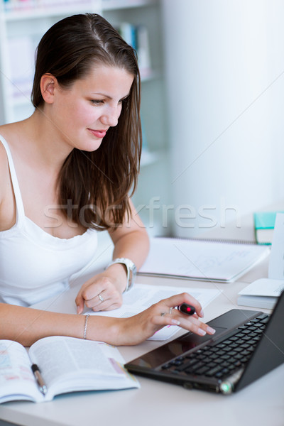 pretty female college student studying in the university library Stock photo © lightpoet