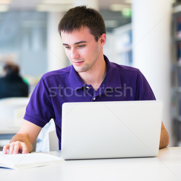Handsome college student using his laptop computer in the campus Stock photo © lightpoet