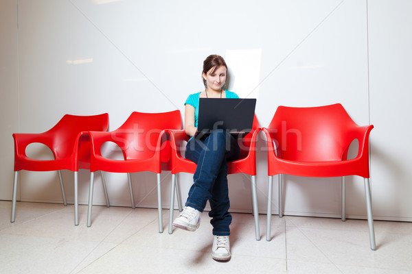 Pretty young female student with laptop  Stock photo © lightpoet