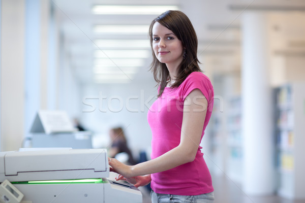 pretty young woman using a copy machine (shallow DOF; color tone Stock photo © lightpoet