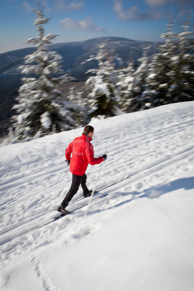 Cross-country skiing: young man cross-country skiing on a lovely Stock photo © lightpoet