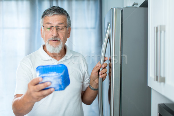 Is this still fine? Senior man in his kitchen by the fridge Stock photo © lightpoet