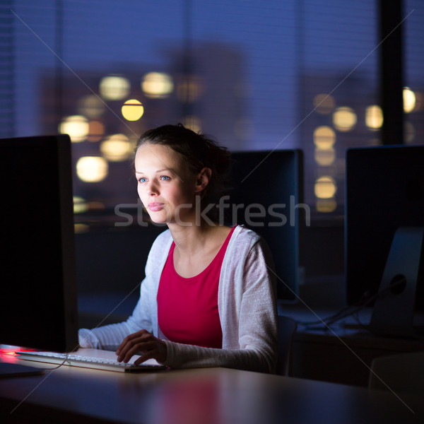 Pretty, young female college student using a desktop computer/pc Stock photo © lightpoet