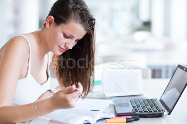 pretty female college student studying in the university library Stock photo © lightpoet