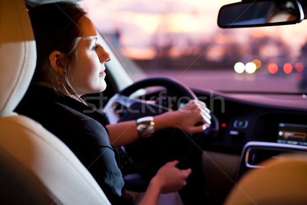 Młoda kobieta jazdy nowoczesne samochodu noc miasta Zdjęcia stock © lightpoet