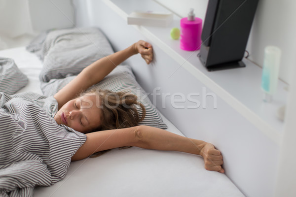 Pretty, young woman stretching in bed after waking up Stock photo © lightpoet