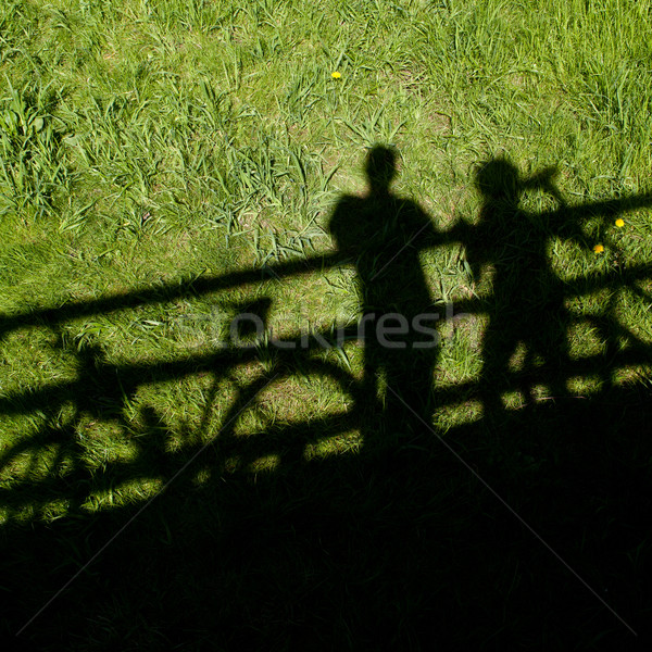 two mountain bikers' silhouettes during a halt on a bridge Stock photo © lightpoet