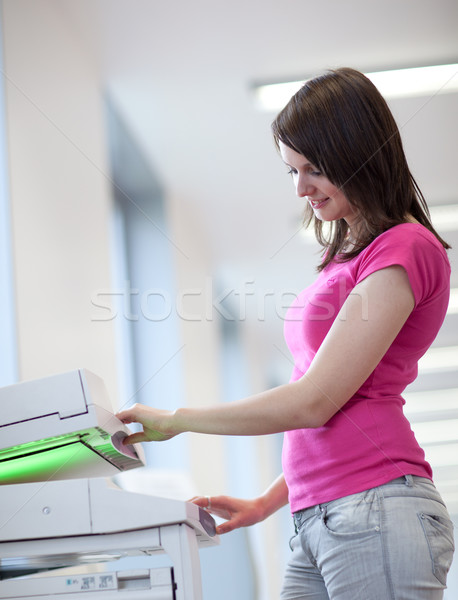 pretty young woman using a copy machine (shallow DOF; color tone Stock photo © lightpoet