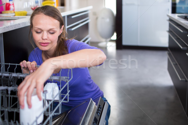 Pretty, young woman in her modern and well equiped kitchen  Stock photo © lightpoet