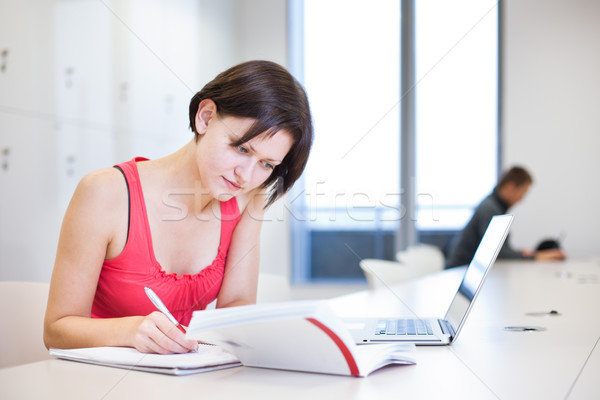 Pretty young college student studying in the library/a study roo Stock photo © lightpoet