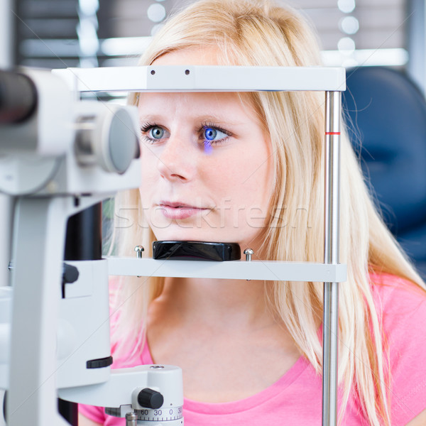 young female patient having her eyes examined by an eye doctor Stock photo © lightpoet