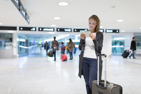 Young female passenger at the airport, using her tablet computer Stock photo © lightpoet