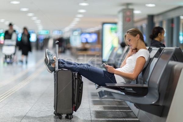 Young female passenger at the airport, using her tablet computer Stock photo © lightpoet